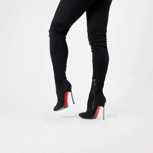 Slim legs in black boots and pants. Walking in high heels. Stiletto shoes — Stock Photo, Image