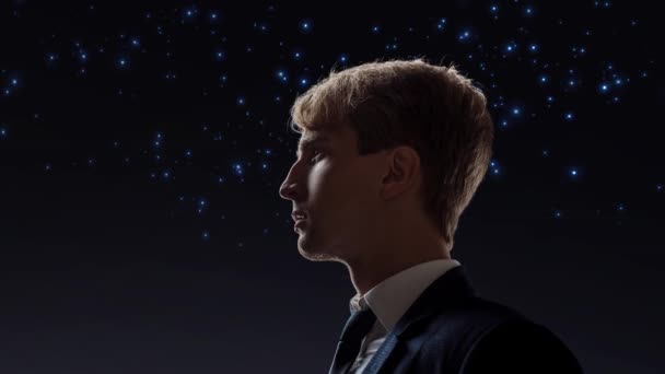 Young male businessman on the background of the starry sky. — Stock Video