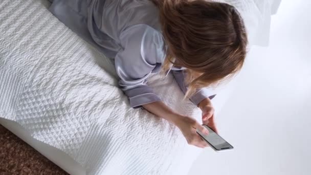 Νεαρή γυναίκα χρησιμοποιεί ένα smartphone, επικοινωνώντας με τους άμεσους αγγελιοφόρους και να χρησιμοποιήσετε την εφαρμογή για κινητά — Αρχείο Βίντεο