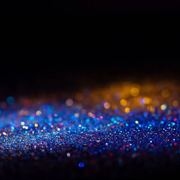 Veelkleurige glanzende glitter in focus en onscherp, abstracte glanzende achtergrond — Stockfoto