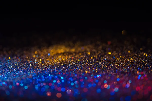 Veelkleurige glanzende glitter in focus en onscherp, abstracte glanzende achtergrond — Stockfoto
