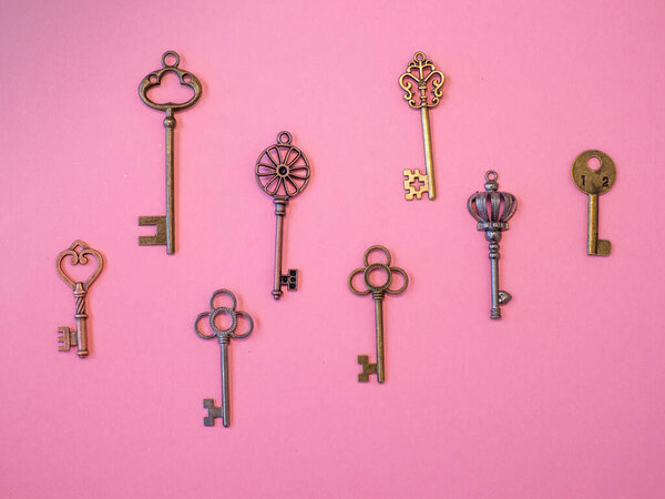 Many different old keys from different locks, in order, flat lay.