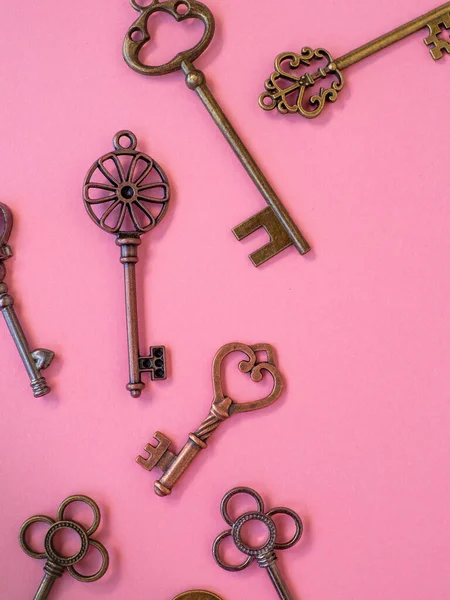 Many different old keys from different locks, scattered chaotically, flat lay.