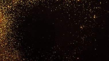 Siyah arka planda parıldayan altın parıltısı, büyülü soyut bir arka plan. Altın parçacıklarından yapılmış yuvarlak çerçeve,