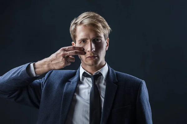 Businessman draws two stripes on his cheeks, war paint. Competition in business, concept. — Stock Photo, Image