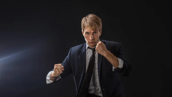 Competition in business, concept. A young man in a suit and tie fights with his fists, — Stock Photo, Image