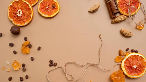 Zitrusfrüchte und würziger Hintergrund mit Kaffeebohnen und Gewürzen, warmer ockerfarbener Hintergrund — Stockfoto