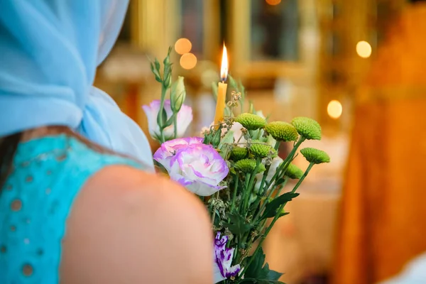 The rite of infant christianity in the church, flowers and lighted candles