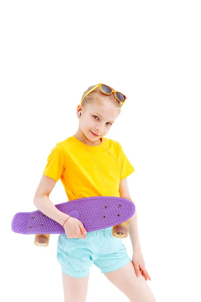 Happy girl with skateboard isolated on white in studio. — Stock Photo, Image
