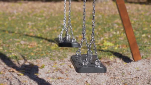 Empty swings at playground — Stock Video