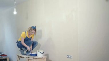 Young woman makes repairs