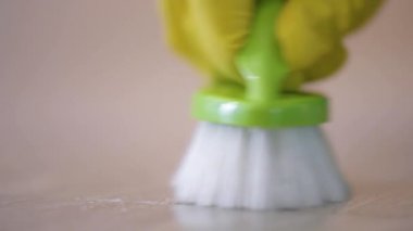 Young woman cleaning floor at room