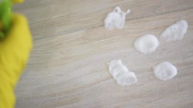 Young woman cleaning floor at room