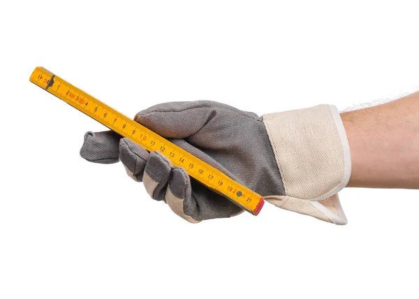 Hand mit Handschuh und Holzmeter — Stockfoto