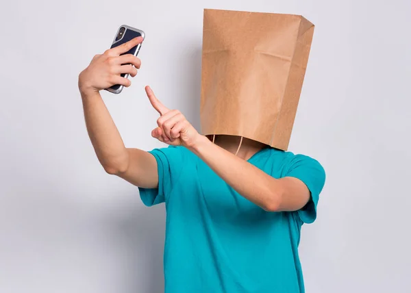 Boy with paper bag over head