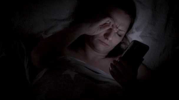 Mujer usando celular en la cama — Vídeos de Stock