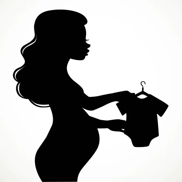 美しい若い妊娠中の女性のシルエットは 白い背景に隔離されたハンガーに幼児の体を考えます — ストックベクタ