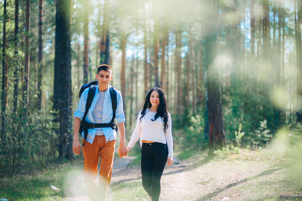 A young couple is resting on nature.