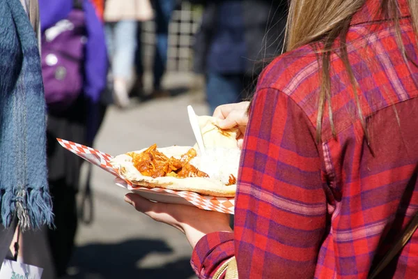 Young woman with Indian takeaway at the Ballard Farmer\'s Market on a spring day in Seattle, Washington