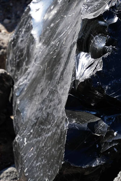 Large chunks of black obsidian glass exposed in the Newberry National Volcanic Monument, Oregon