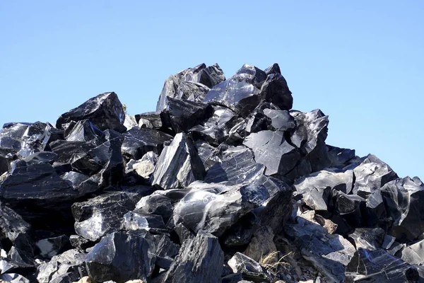 Large chunks of black obsidian glass exposed in the Newberry National Volcanic Monument, Oregon
