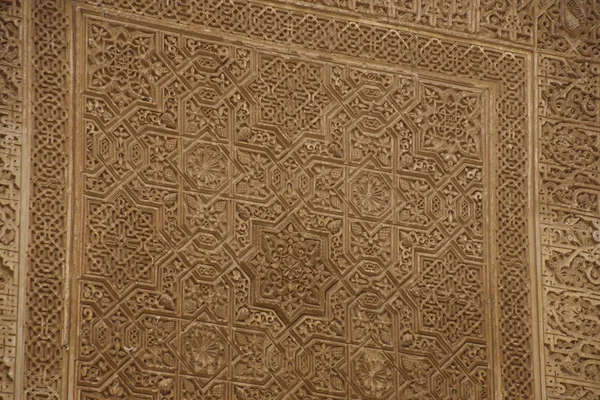 GRENADA, SPAIN - NOV 23, 2018 - Islamic patterns on the wall of the Alhambra Palace, Grenada, Spain