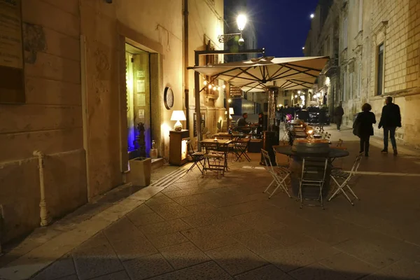 Evening diners at outdoor tables,