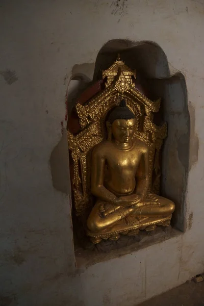 Buddhist statues inset in alcove of the Ananda Phaya Temple