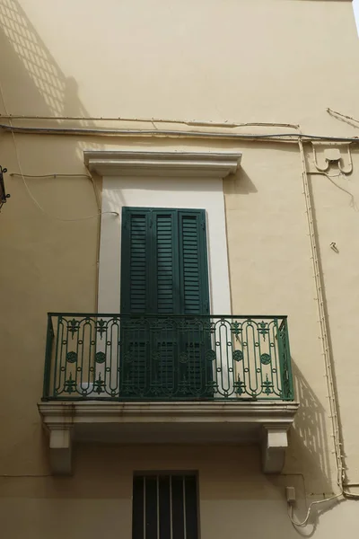 Green door and balcony of a baroque palace