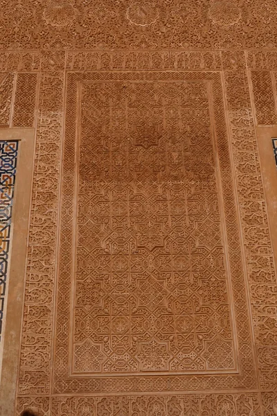 GRENADA, SPAIN - MAR 8, 2020 - Islamic patterns on the wall of the Alhambra Palace, Grenada, Spain