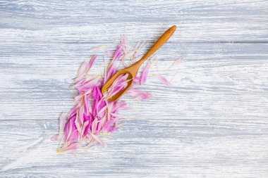 pembe şakayık yaprakları rustik bir arka plan üzerinde tahta kaşıkla. Alan, üstten görünüm kopyalayın. Çiçek kompozisyon.