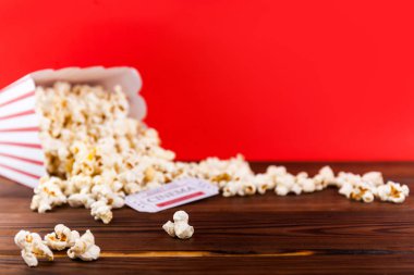 Kırmızı ve beyaz kova patlamış mısır iki kırmızı film bilet ile. Film gecesi kapatmak kırmızı üzerine