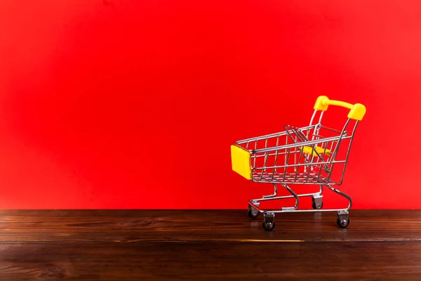 Empty Shopping Cart Parking Yellow Background Copyspace Retail Store — Stock Photo, Image