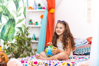 Sevimli küçük kız şirin Arapça iç bir küre tutuyor. Seyahat kavramı.