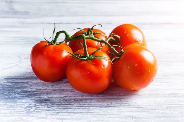 Fresh grape tomatoes with for use as cooking ingredients on rustic table