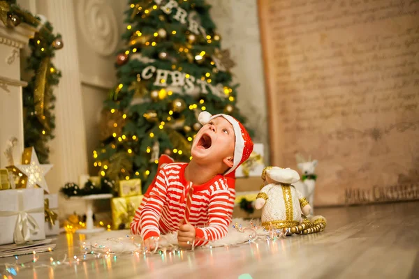 Lindo Niño Pijama Rojo Rayado Sombrero Encuentra Cerca Árbol Navidad —  Fotos de Stock