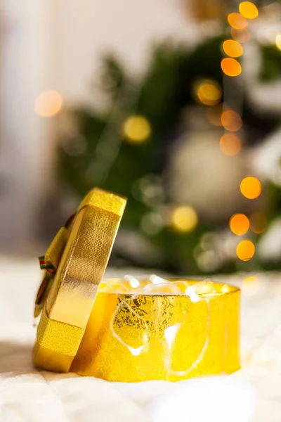 golden round gift boxes sparkling with bow on Christmas background