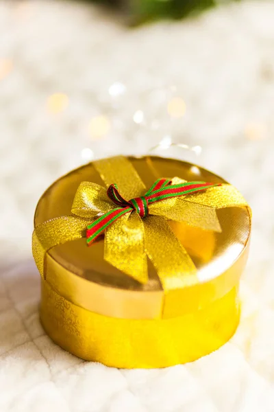 golden round gift boxes sparkling with bow on Christmas background