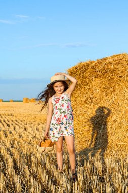 Ekmek sepeti ile gün batımında çavdar alanında sevimli kız.
