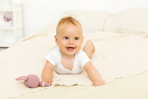 Portrait de sourire heureux bébé relaxant sur le lit — Photo