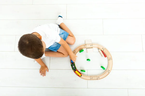 Little boy playing with toy train at home — Stock Photo, Image