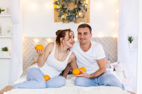 Couple of lovers in pajamas lying on the sofa. Christmas time. Holiday at home — Stock Photo, Image