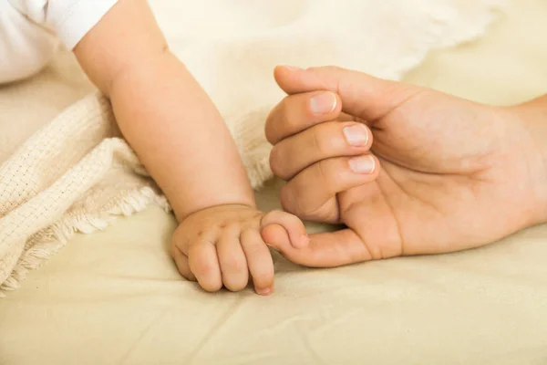 Les mains du bébé et de la mère se rapprochent. Concept de famille — Photo