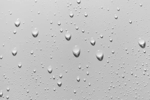 Close up of water drops with shadows on grey tone background. Abstract gray wet texture with bubbles on plastic PVC surface. Realistic pure water droplets condensed. Detail of canvas leather texture