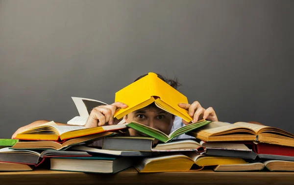 Scared Man Peeks Out Book Littered Pile Colorful Books His — Stock Photo, Image