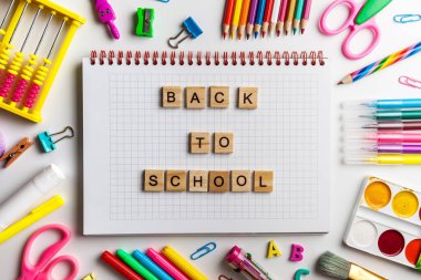 Okul ofis malzemeleri fotokopi alanı olan bir masada. Tahta bloklardan yapılmış okul metnine geri dön