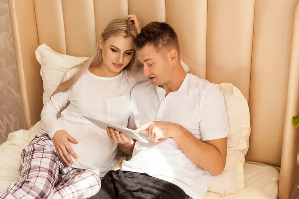 Pregnant Woman Man Lying Bed Home Shopping Online Looking Something — Stock Photo, Image