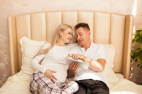 Pregnant Woman Man Lying Bed Home Shopping Online Looking Something — Stock Photo, Image