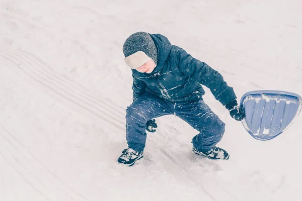Ένα Αγόρι Στα Ρούχα Του Σκι Ενδίδει Ένα Λόφο Χιονιού — Φωτογραφία Αρχείου