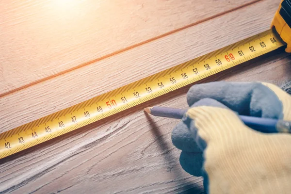 Worker Construction Measuring Tape Makes Measurements Wooden Floor — Stock Photo, Image